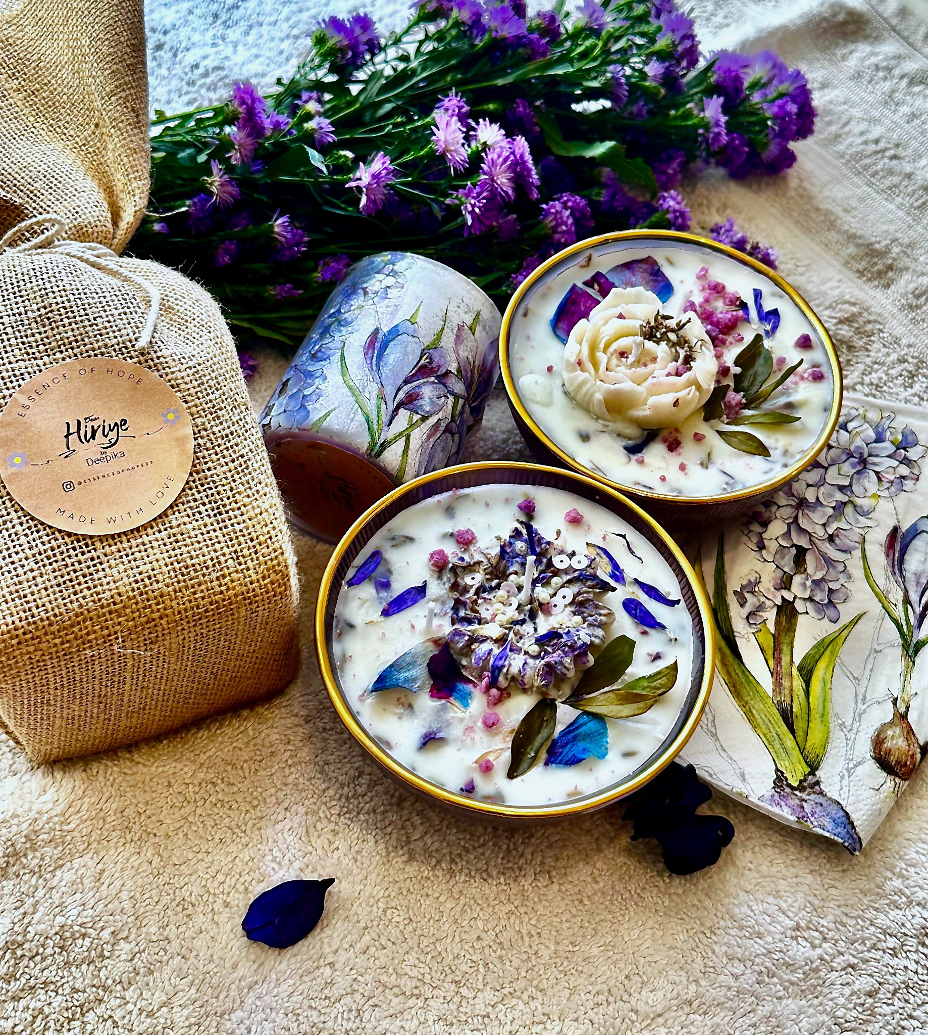 Hiriye — the studio's first candle, wrapped in burlap and pressed with dried garden flowers
