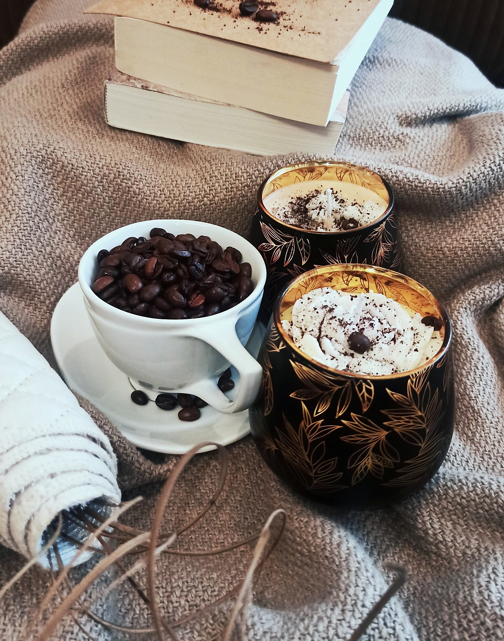 Black and gold vessel candle with fresh coffee beans, on a hand-loomed jute mat